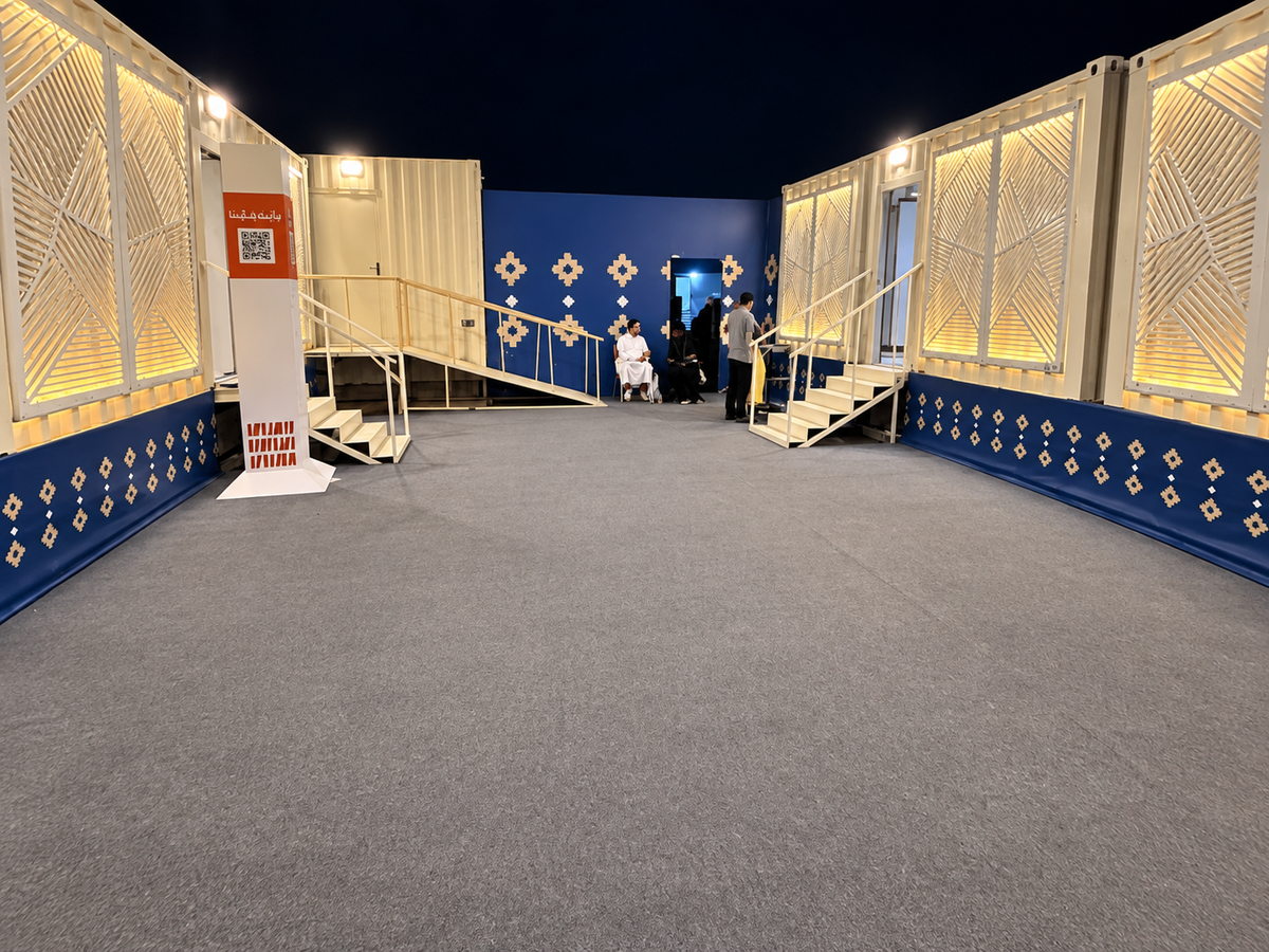 International Book Fair — restroom unit walkway with illuminated screen facades