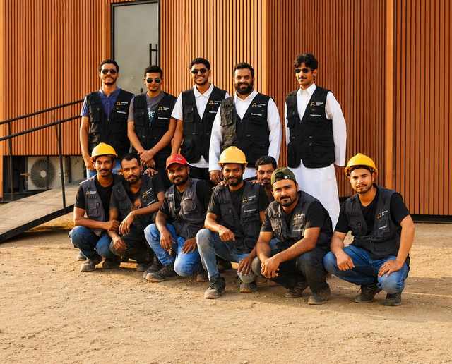Advance Cabin field team — supervisors and technicians in front of a modular unit on site